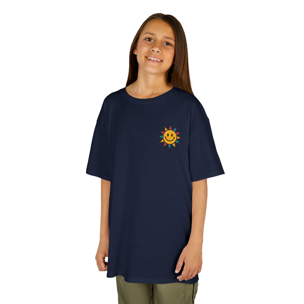 Child wearing a navy blue t-shirt featuring a cheerful sun graphic, promoting kindness and positivity for back-to-school.