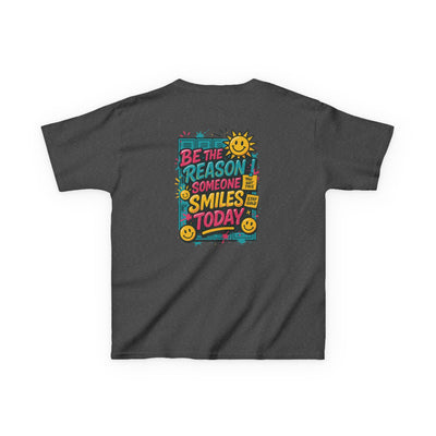 Kids motivational back-to-school tee featuring a cheerful graphic saying 'Be The Reason Someone Smiles Today' on a dark shirt.
