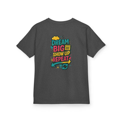 Back view of a kids' motivational tee featuring colorful text: Dream Big. Show Up. Repeat.