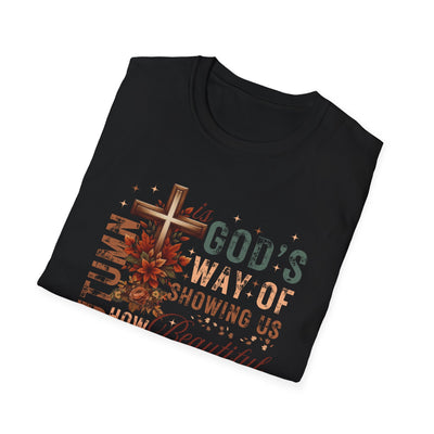 Black tee featuring the phrase 'Autumn Is God's Way of Showing Us How Beautiful' with autumn-themed graphics.
