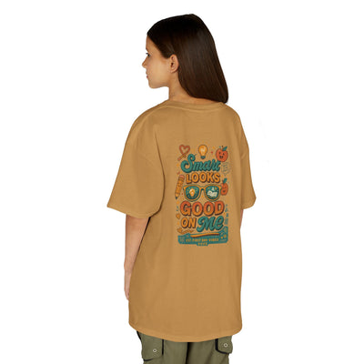 Back view of a child wearing a motivational Smart Looks Good On Me back-to-school tee in tan color.