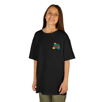 Smiling child wearing a black Dream Big motivational t-shirt, perfect for back-to-school confidence and style.