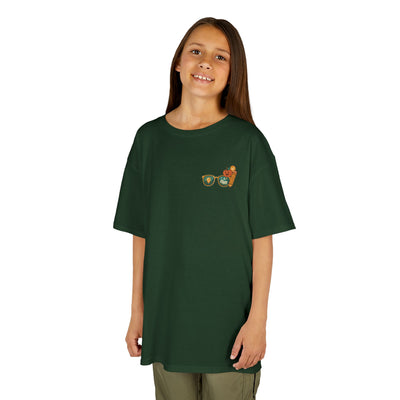 Smiling child wearing a green Smart Looks Good On Me t-shirt with graphic glasses, perfect for back-to-school style.