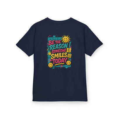 Navy kids t-shirt with colorful 'Be The Reason Someone Smiles Today' graphic and cheerful sun design.