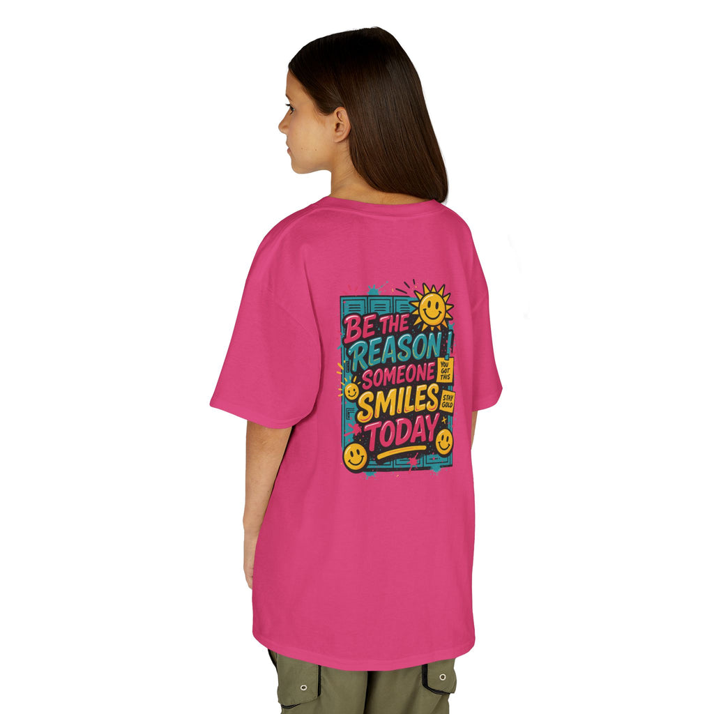 Kids' back view of pink Be The Reason Someone Smiles Today motivational tee with cheerful sun graphic.