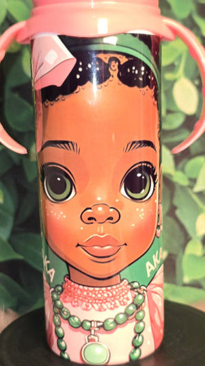 Sippy cup with a colorful design of a girl's face on a green leafy background