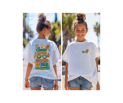 Girl wearing Smart Looks Good On Me back-to-school tee with motivational design, shown from the back and front in sunlight.