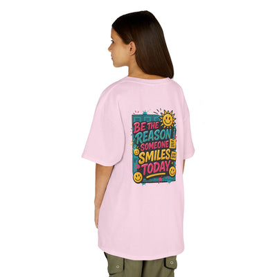 Kids pink t-shirt with 'Be The Reason Someone Smiles Today' graphic, perfect for back-to-school motivation.