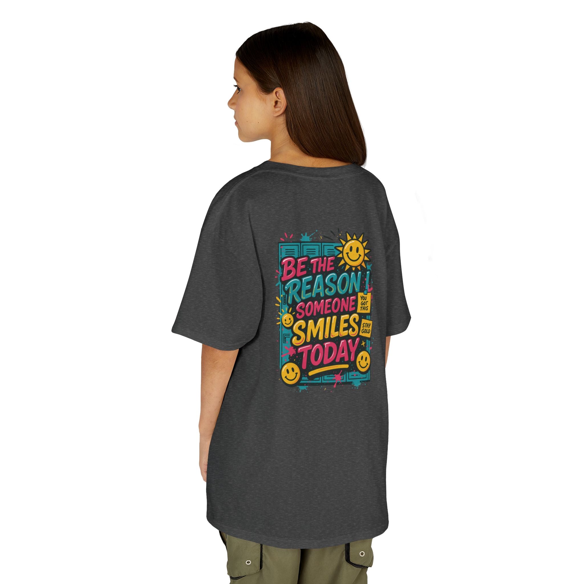 Kid wearing a back-to-school tee with 'Be The Reason Someone Smiles Today' graphic, bright and cheerful design.