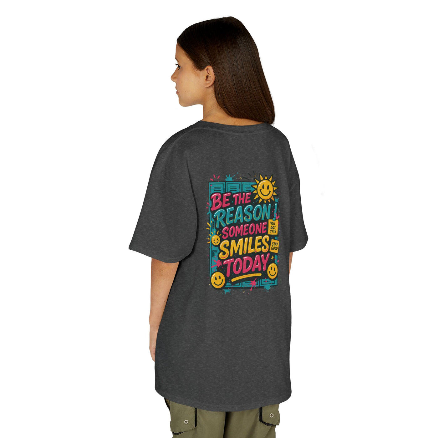 Kid wearing a back-to-school tee with 'Be The Reason Someone Smiles Today' graphic, bright and cheerful design.