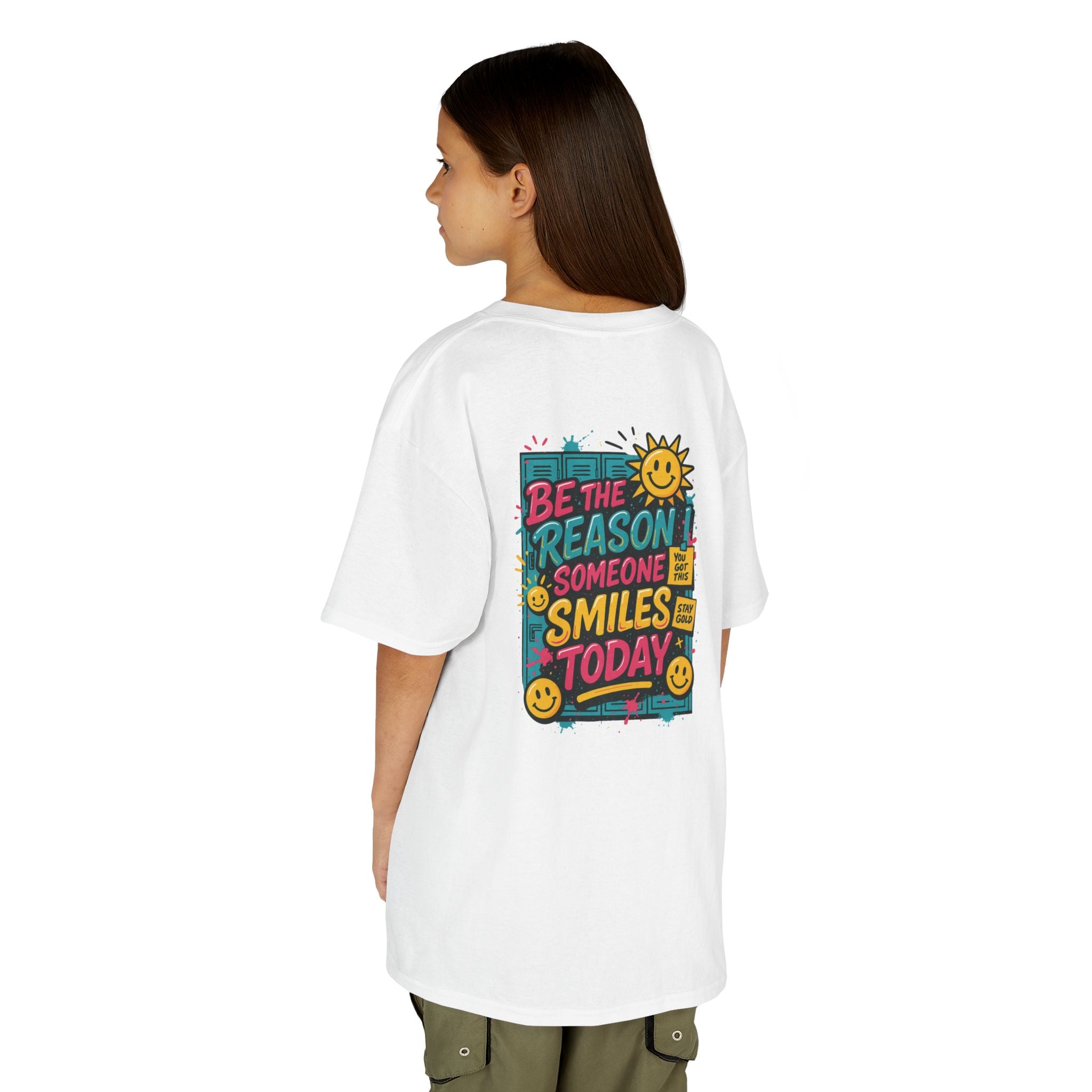 Kids motivational back-to-school tee with cheerful sun graphic and "Be The Reason Someone Smiles Today" text on back.