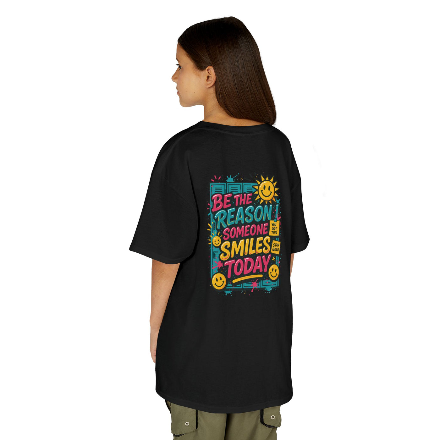 Back view of kids' black t-shirt with colorful 'Be The Reason Someone Smiles Today' graphic design.