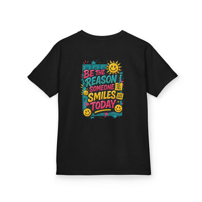 Black kids t-shirt featuring the motivational quote 'Be The Reason Someone Smiles Today' with cheerful graphics.