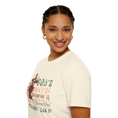 Model wearing a faith-inspired fall tee that celebrates change, featuring warm autumn colors and a positive message.