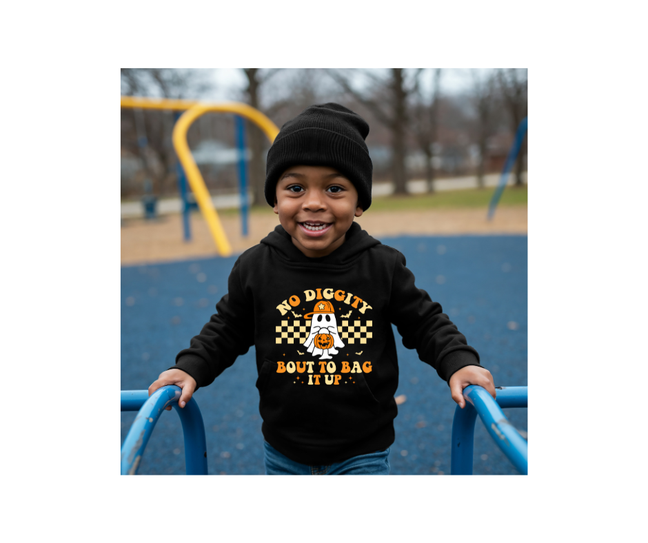 Child wearing a hoodie with text on a playground
