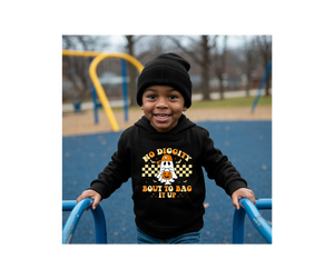Child wearing a hoodie with text on a playground