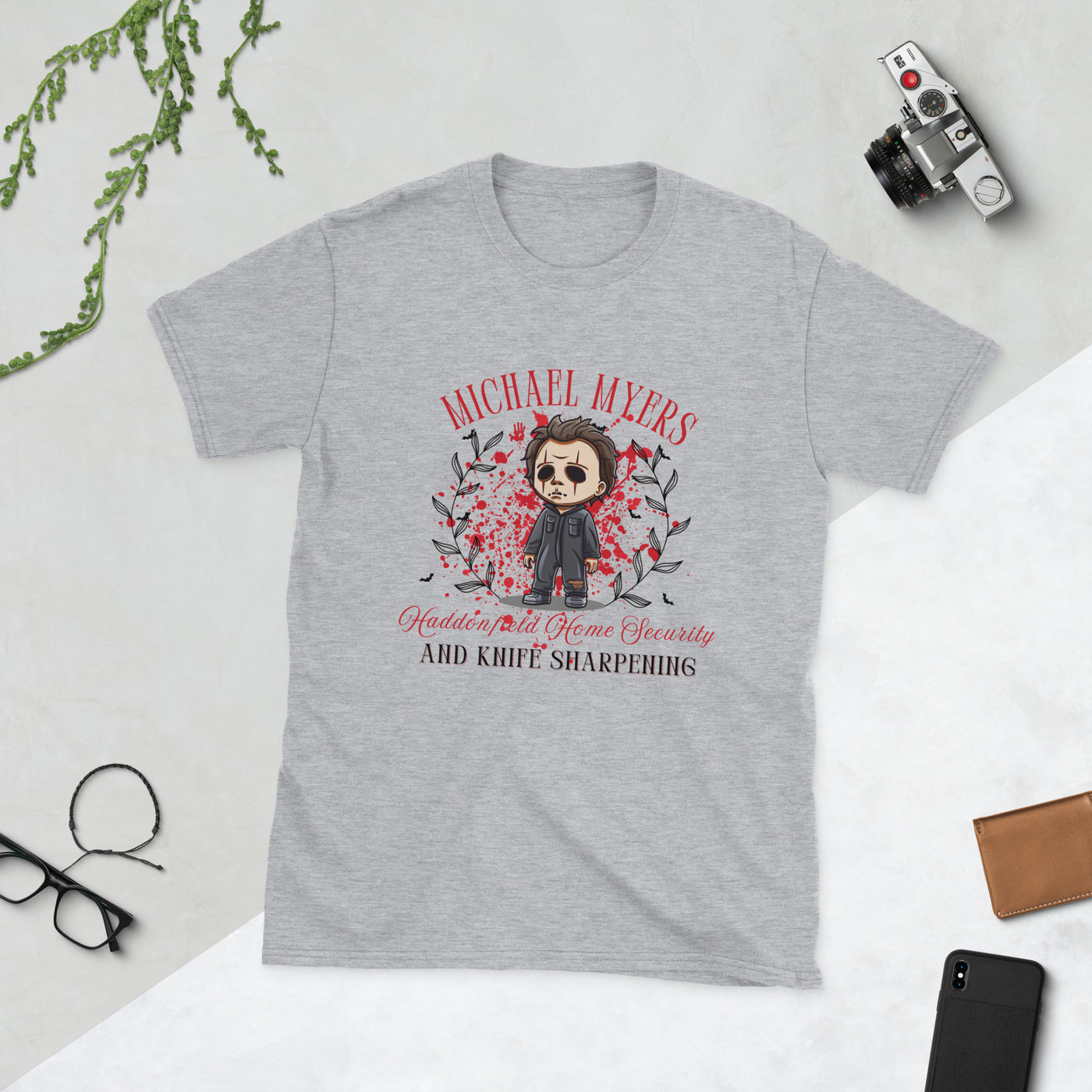 Michael Myers Halloween t-shirt with cartoon graphic, featuring home security and knife sharpening themes.