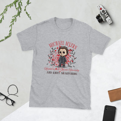 Michael Myers Halloween t-shirt with cartoon graphic, featuring home security and knife sharpening themes.